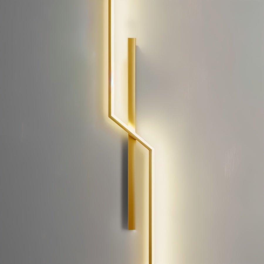 Modern slant wall lamp by Residence Supply with a sleek metal finish and adjustable arm, mounted on a neutral-colored wall.