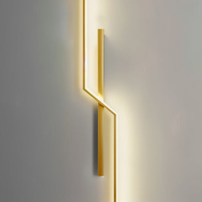 Modern slant wall lamp by Residence Supply with a sleek metal finish and adjustable arm, mounted on a neutral-colored wall.