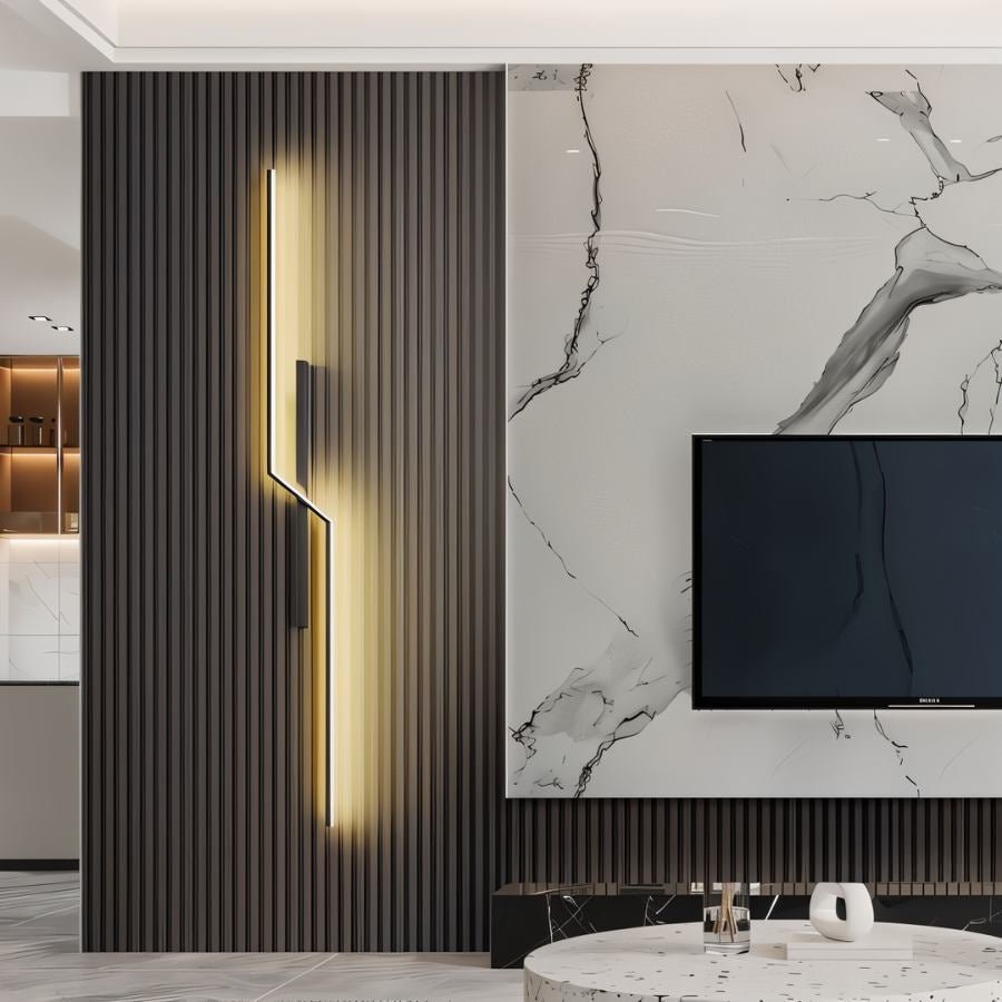Modern slant wall lamp by Residence Supply mounted on a wall with a sleek metal finish and adjustable arm for focused lighting.