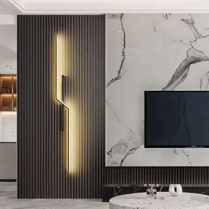 Modern slant wall lamp by Residence Supply mounted on a wall with a sleek metal finish and adjustable arm for focused lighting.