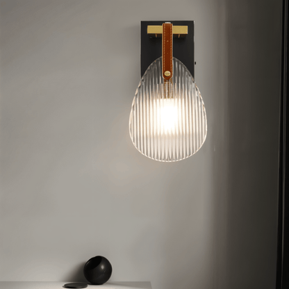 Residence Supply Solya Wall Lamp mounted on a wall with a sleek, modern design and warm lighting.