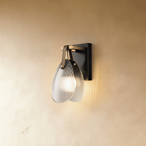 Residence Supply Solya Wall Lamp mounted on a wall with a sleek, modern design and warm lighting.
