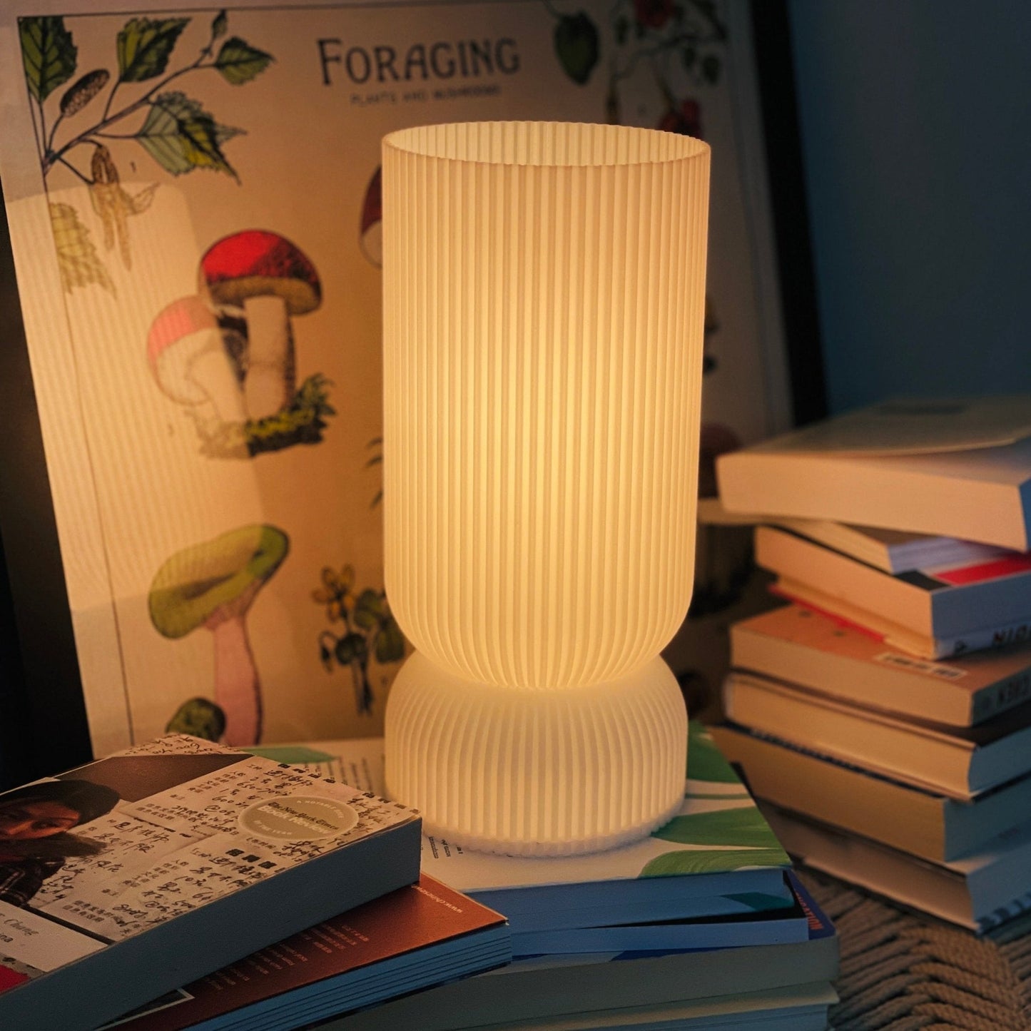 Terra Labs Stance Table Lamp with a sleek modern design, featuring a cylindrical base and a fabric shade on a wooden table.