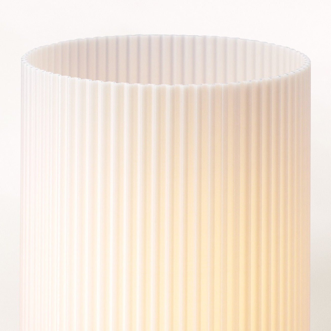 Terra Labs Stance Table Lamp with a sleek, modern design featuring a white shade and wooden base on a bedside table.