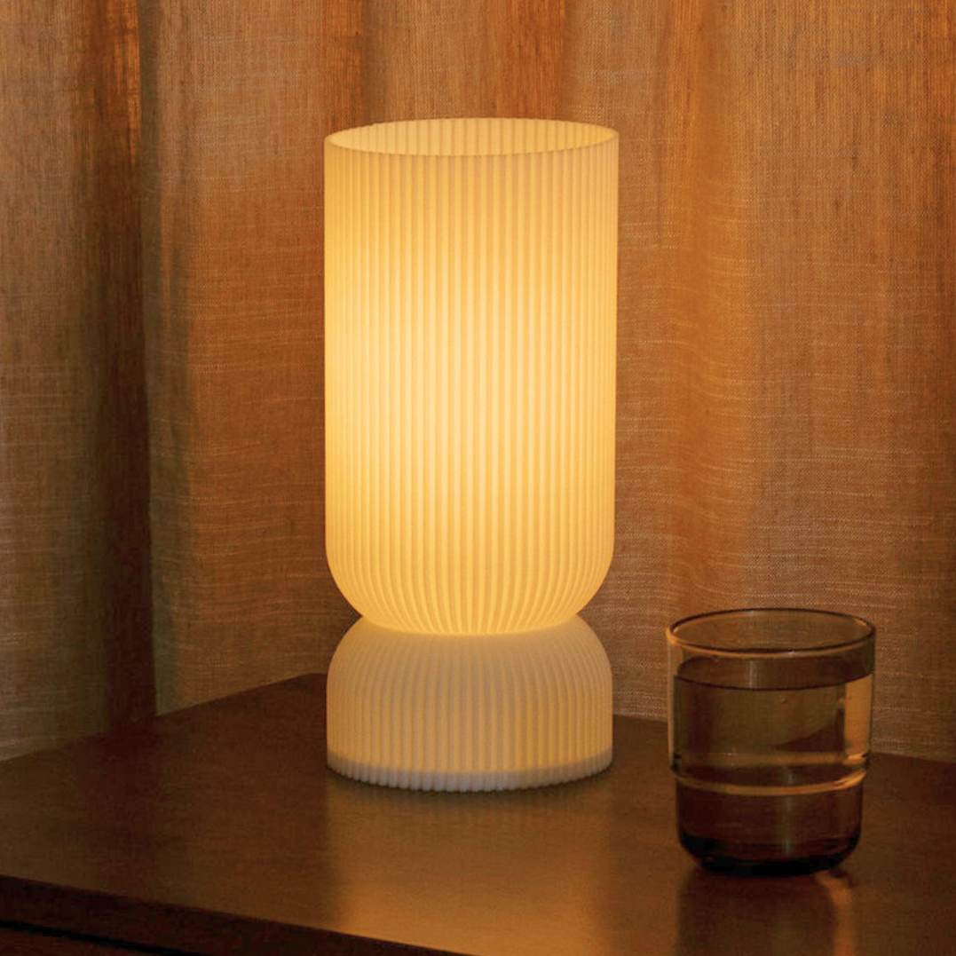 Terra Labs Stance Table Lamp with a sleek modern design, providing bright, ambient lighting for a bedroom or living space.