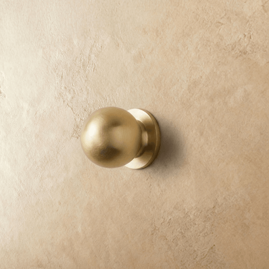 Residence Supply Suro knob, round cabinet hardware with a brushed nickel finish, mounted on a wooden cabinet.