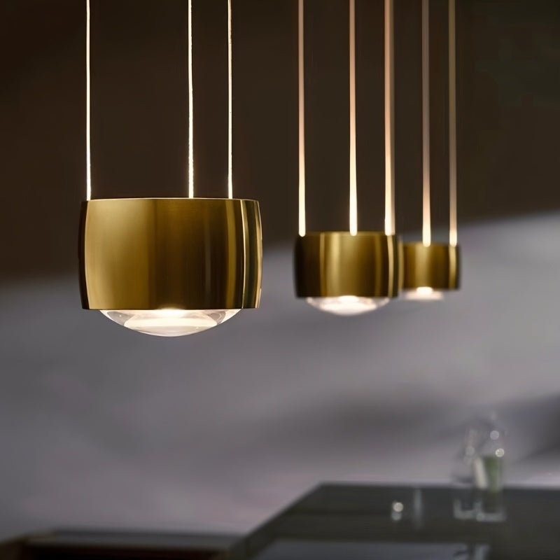 Tejas Pendant Light by Residence Supply hanging from ceiling, featuring a modern design with metal and glass elements.