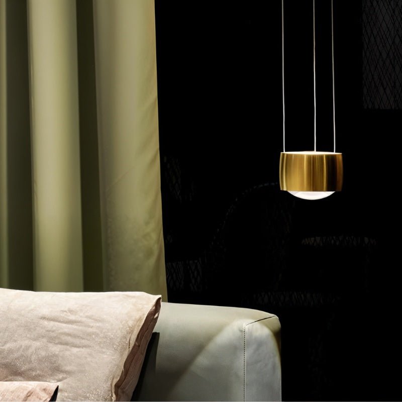 Tejas Pendant Light by Residence Supply hanging from ceiling with a modern design, featuring a sleek metal finish and warm lighting.