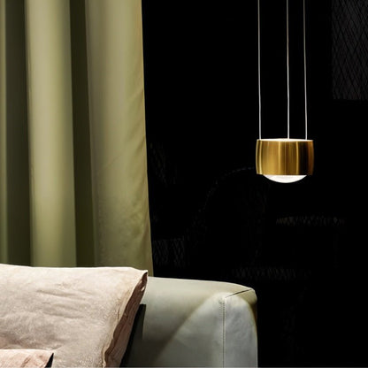 Tejas Pendant Light by Residence Supply hanging from ceiling with a modern design, featuring a sleek metal finish and warm lighting.