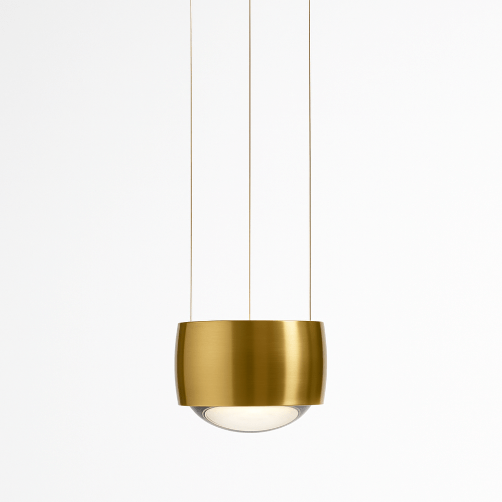 Tejas Pendant Light by Residence Supply hanging from ceiling with a modern metallic design and warm illumination.