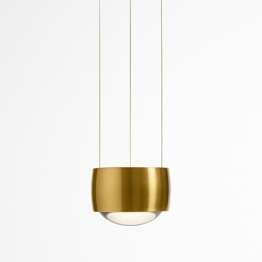 Tejas Pendant Light by Residence Supply hanging from ceiling with a modern metallic design and warm illumination.
