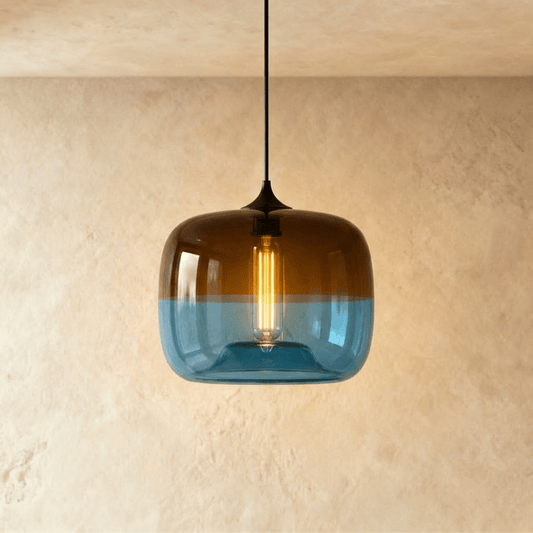 Teleo pendant light by Residence Supply hanging from ceiling with a modern design and warm lighting.