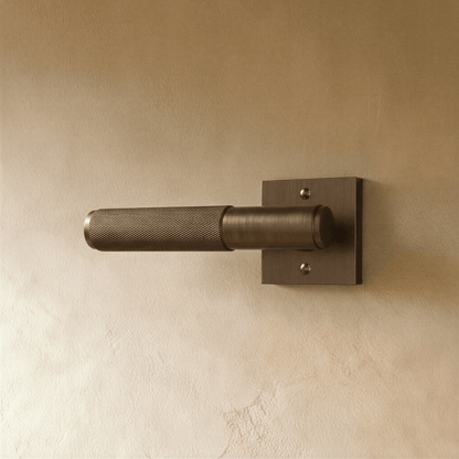 Brass door handle from Residence Supply with a polished finish, mounted on a wooden door for home and garden door hardware.