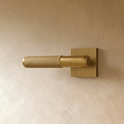 Open-box brass door handle from Residence Supply, showcasing a polished metal finish and ergonomic design for home door hardware.