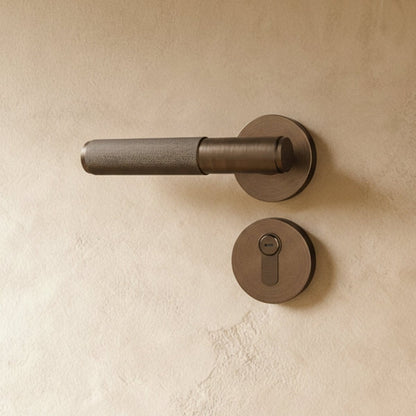 Brass door handle from Residence Supply, installed on a door, showcasing its polished finish and ergonomic design for home hardware.