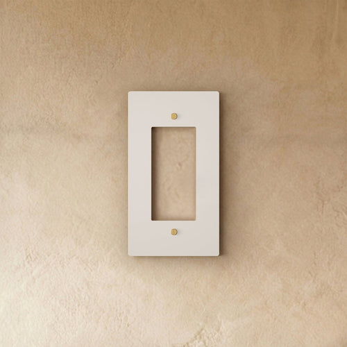 White wall plate with brass accents from Residence Supply, suitable for home electrical outlets and switches.