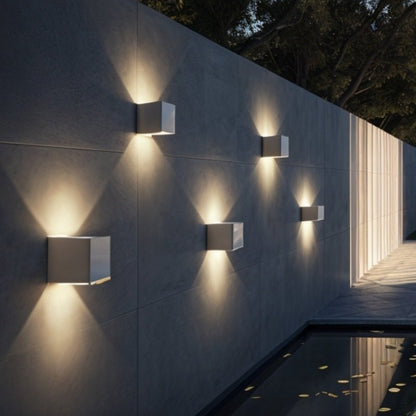 Modern Tine Wall Lamp by Residence Supply featuring sleek metal arm and minimalist design mounted on a wall.