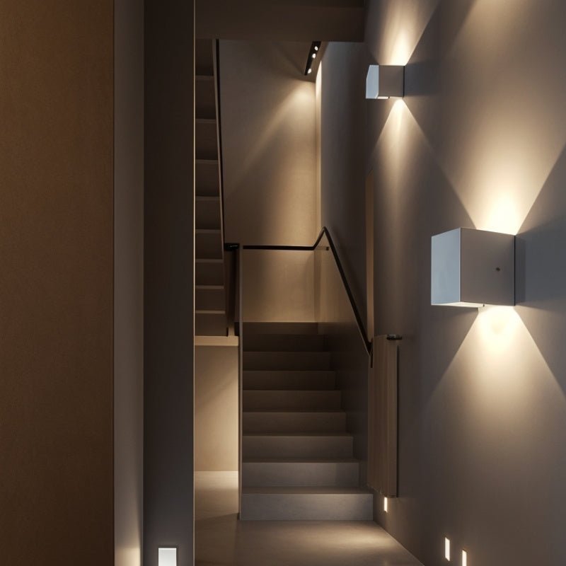 Residence Supply Tine Wall Lamp mounted on hallway wall, featuring modern design with sleek metal finish and warm lighting.