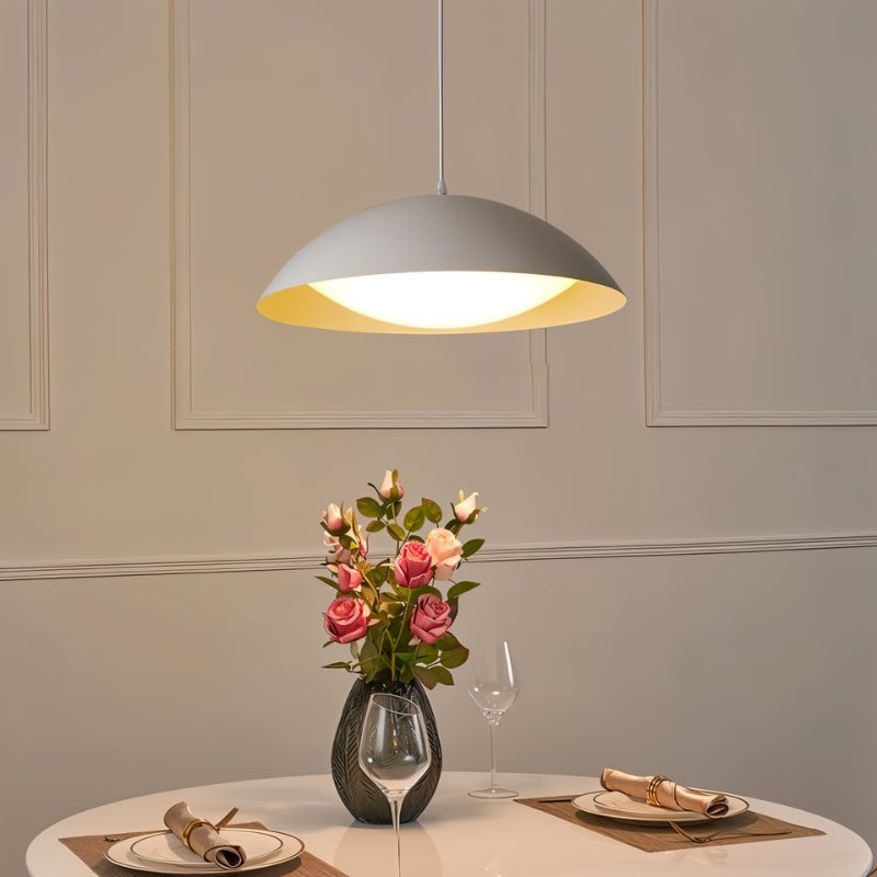 Modern Toviel Pendant Light by Residence Supply with a sleek design and metal finish, hanging from a ceiling fixture.