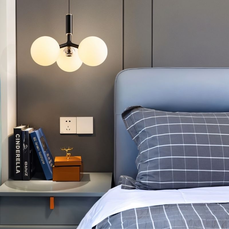 Black Trilume Pendant Light by Residence Supply hanging in a bedroom with a modern design.