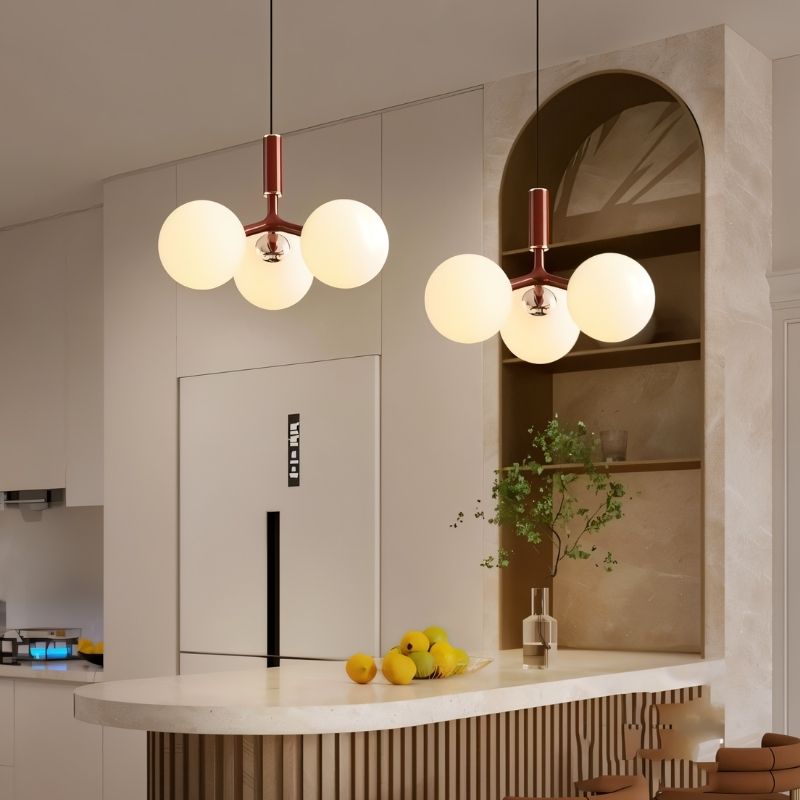 Residence Supply Trilume Pendant Light hanging above a kitchen island, featuring a modern design and warm illumination.