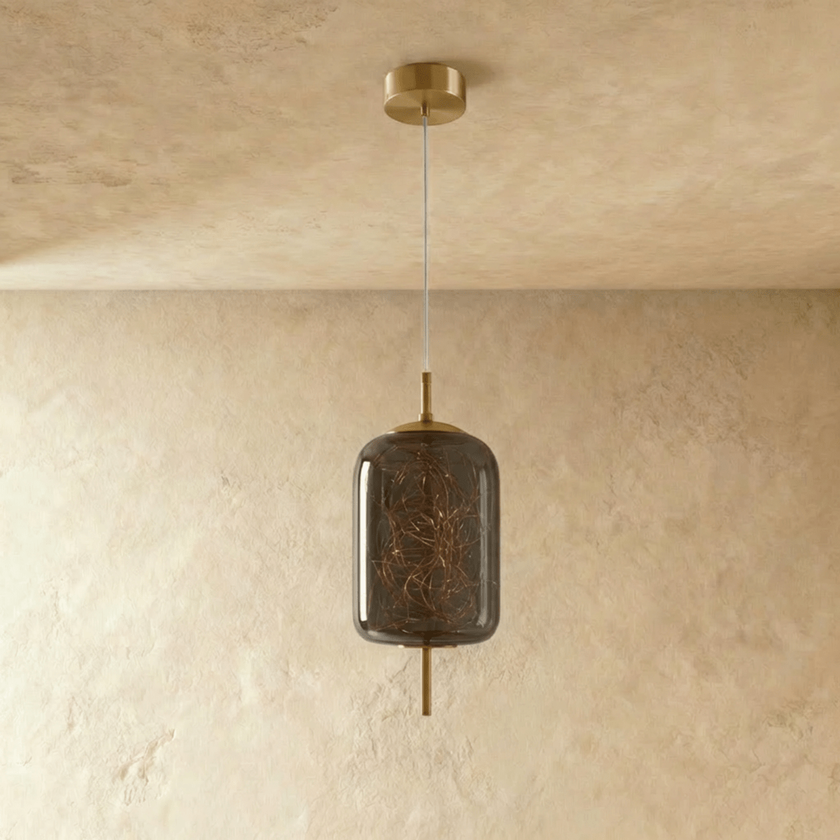 Residence Supply Twirl Pendant Light with modern design, featuring a sleek, curved metal shade hanging from a ceiling mount.