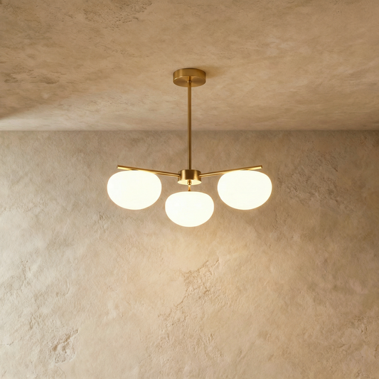 Umera Pendant Lamp by Residence Supply hanging with a sleek, modern design and metallic finish on a neutral background.