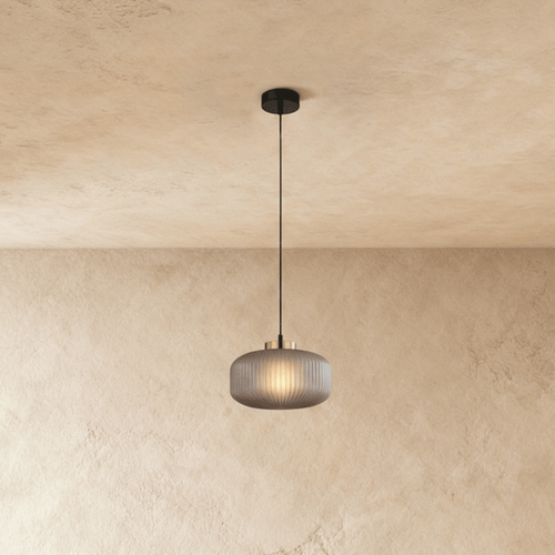 Vahni Pendant Light by Residence Supply hanging from ceiling with a sleek modern design and warm ambient lighting.