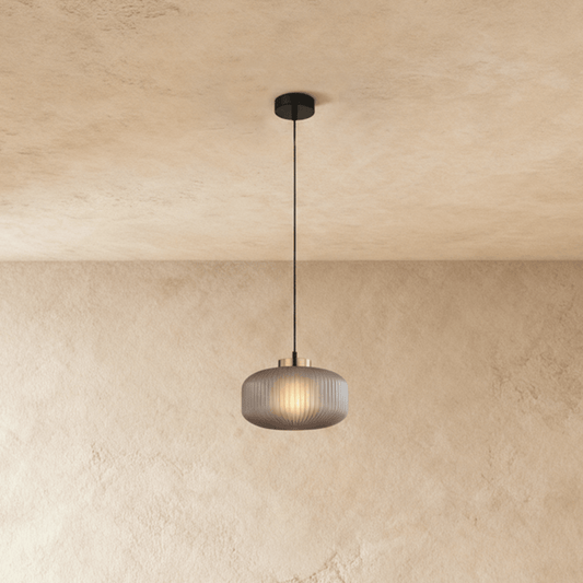 Vahni Pendant Light by Residence Supply hanging from ceiling with a sleek modern design and warm ambient lighting.
