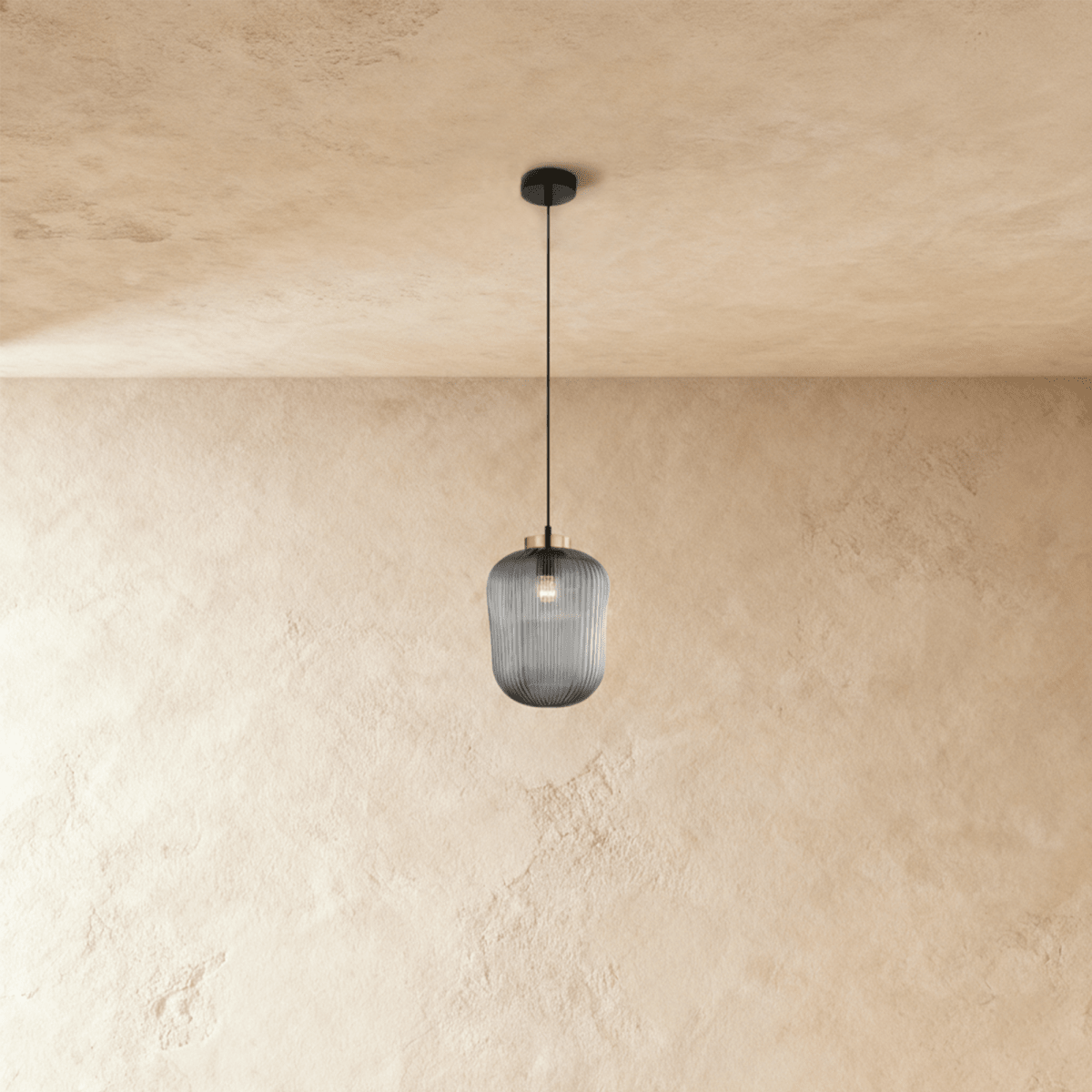 Vahni Pendant Light from Residence Supply featuring a modern design with a sleek metal finish and clear glass shade hanging from a ceiling mount.