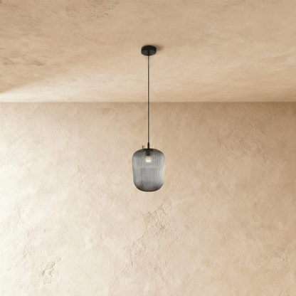Vahni Pendant Light from Residence Supply featuring a modern design with a sleek metal finish and clear glass shade hanging from a ceiling mount.