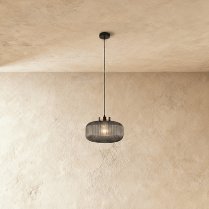 Modern Vahni Pendant Light by Residence Supply featuring a sleek metal design with a clear glass shade.