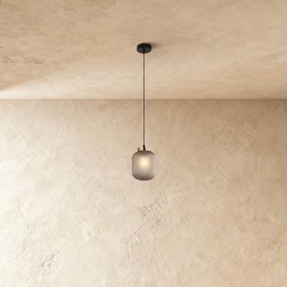 Vahni Pendant Light by Residence Supply hanging from ceiling with a sleek modern design and warm lighting.