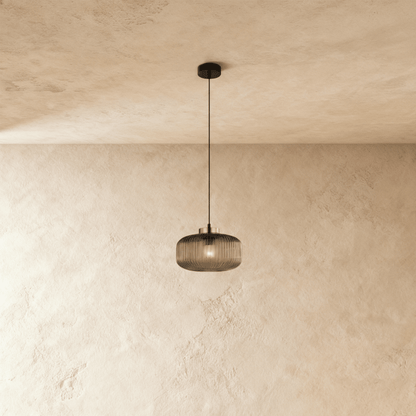 Vahni Pendant Light by Residence Supply hanging from ceiling with a sleek, modern design and warm lighting effect.