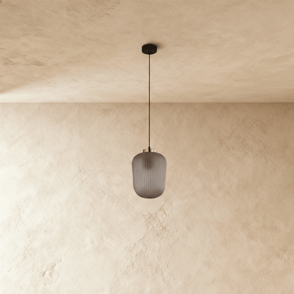 Vahni Pendant Light by Residence Supply hanging from ceiling with a sleek modern design and metal finish.