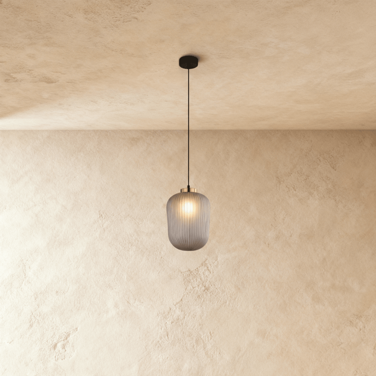 Vahni Pendant Light by Residence Supply hanging from ceiling with a modern design and warm lighting.