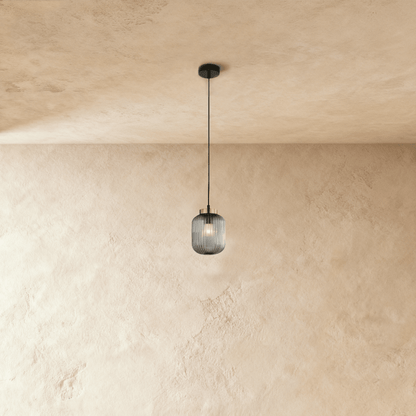 Modern Vahni Pendant Light by Residence Supply with a sleek design, hanging from a ceiling fixture in a contemporary interior setting.