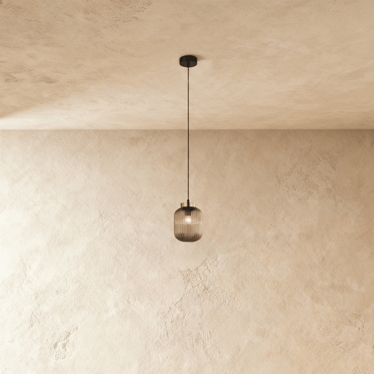 Vahni Pendant Light by Residence Supply hanging from ceiling with a modern design and warm lighting.