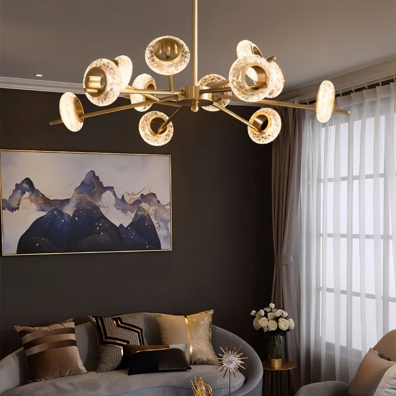 Modern Volrin chandelier by Residence Supply with glass accents, hanging in a contemporary living room.