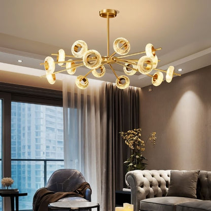 Modern Volrin Chandelier by Residence Supply hanging in a stylish living room with city view, featuring glass design and contemporary lighting.
