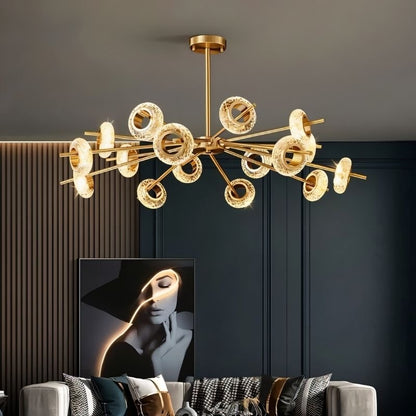 Modern Volrin Chandelier by Residence Supply with glass fixtures, hanging over a stylish living room.