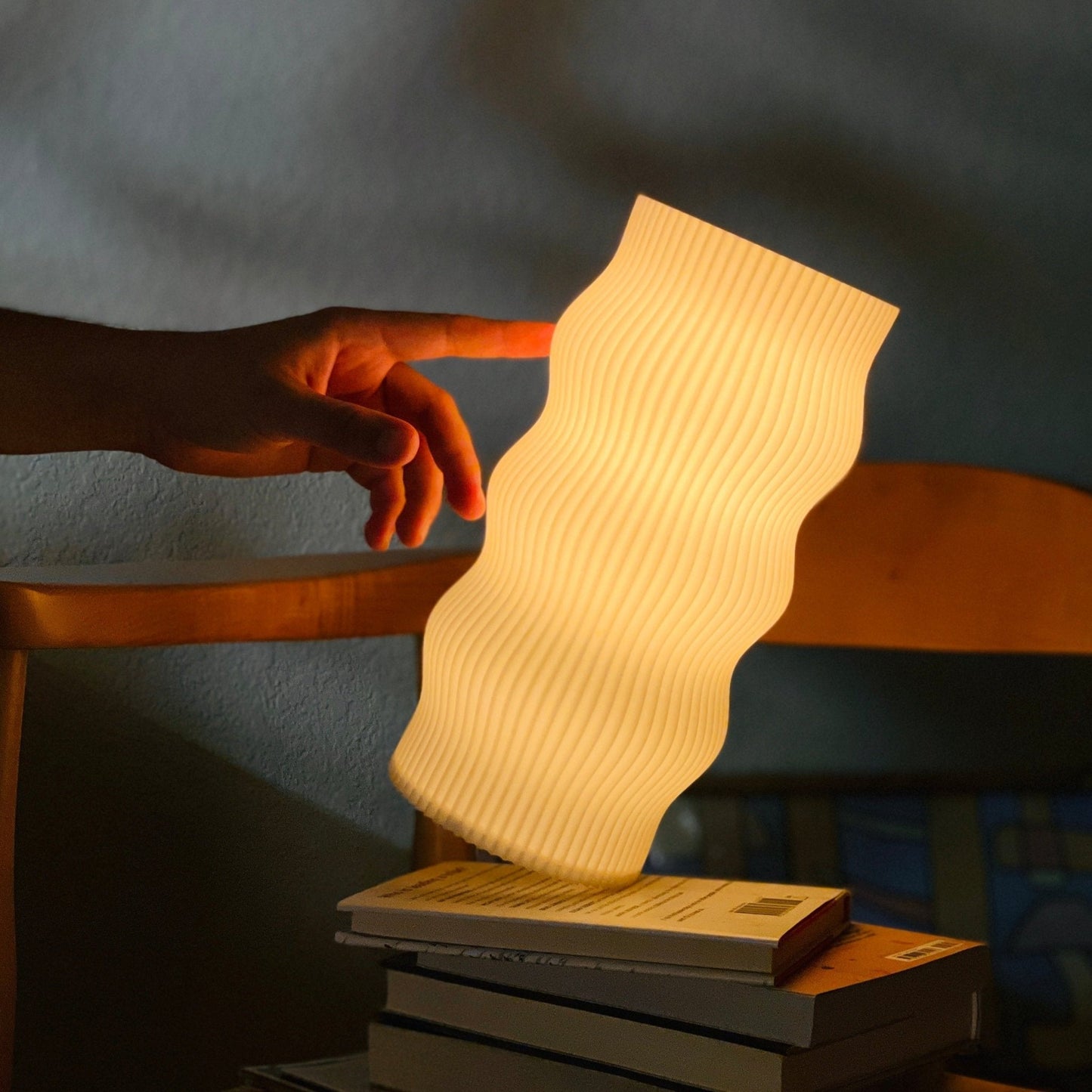 Terra Labs Wub Table Lamp with a sleek, modern design featuring a rounded base and a soft glowing light.