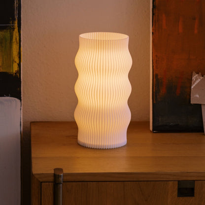 Terra Labs Wub Table Lamp with rounded shape and soft glowing light, perfect for modern home decor.