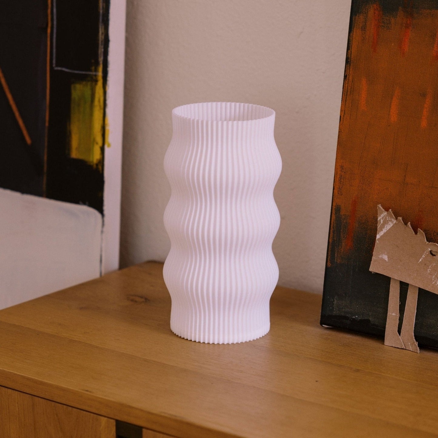Terra Labs Wub Table Lamp with a modern design, featuring a sleek base and a soft glowing lampshade on a side table.