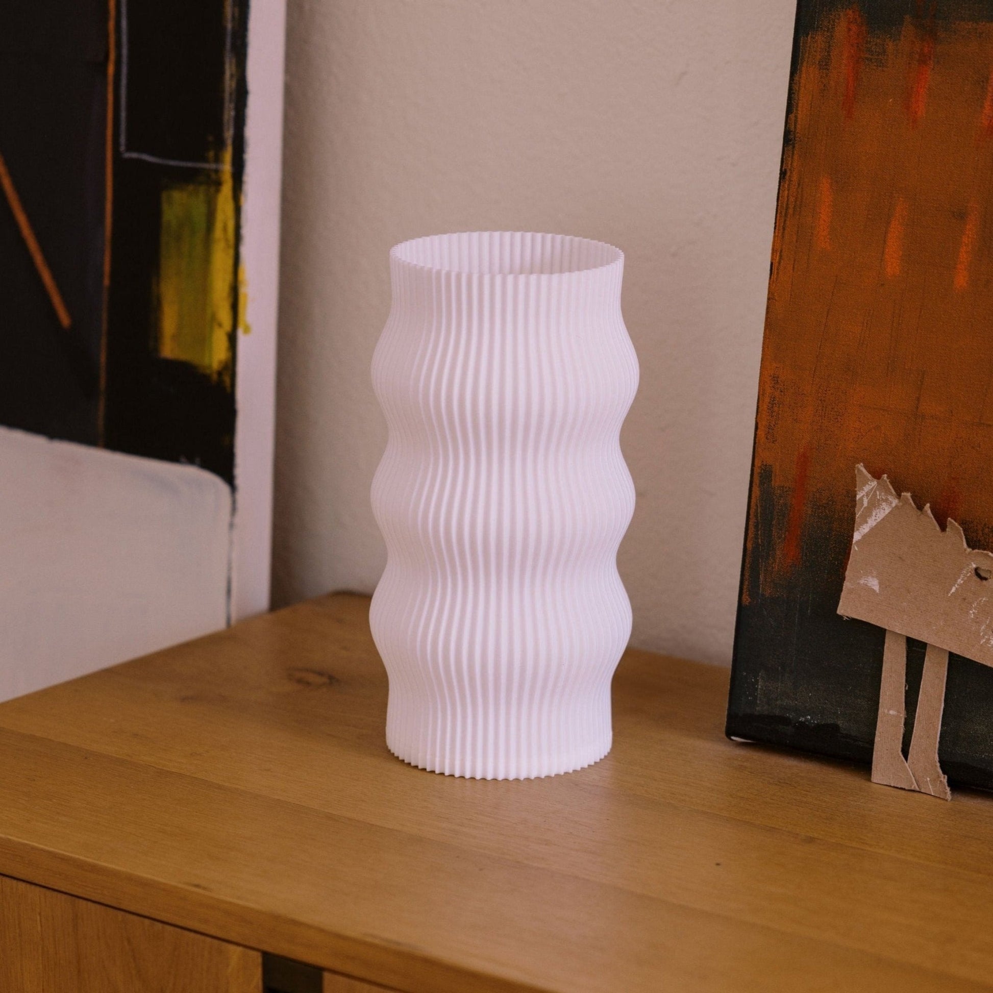 Terra Labs Wub Table Lamp with a modern design, featuring a sleek base and a soft glowing lampshade on a side table.