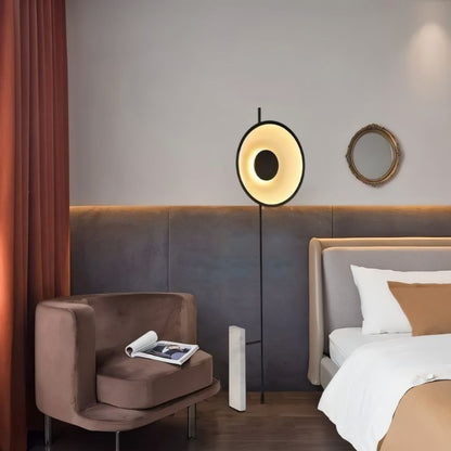 Residence Supply Xyloft Halo Floor Lamp in a bedroom, showcasing its modern design and soft lighting.