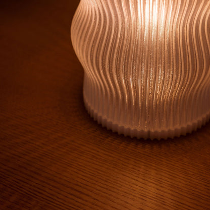 Terra Labs Yuji table lamp with a sleek modern design, featuring a cylindrical base and a soft fabric lampshade.