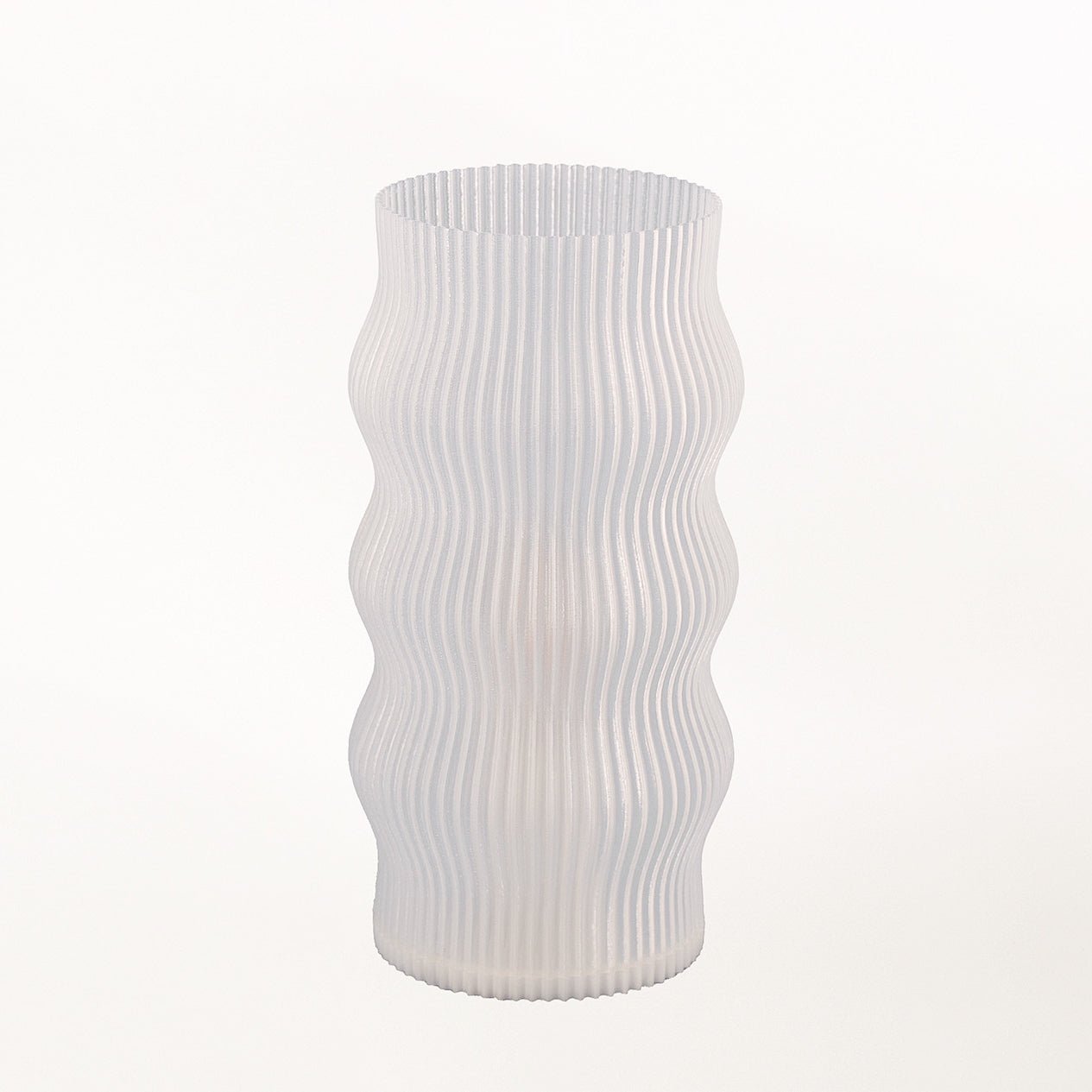 Yuji table lamp by Terra Labs with a modern design, featuring a sleek base and a cylindrical fabric lampshade.