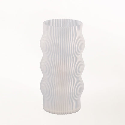 Yuji table lamp by Terra Labs with a modern design, featuring a sleek base and a cylindrical fabric lampshade.