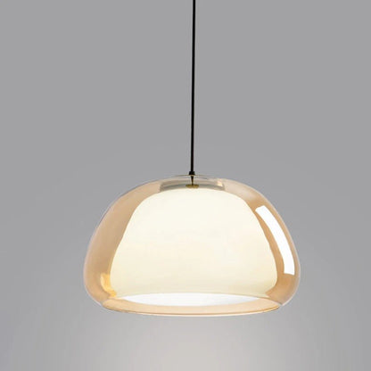 Modern Zabda pendant light by Residence Supply hanging from ceiling with a sleek design and warm lighting.
